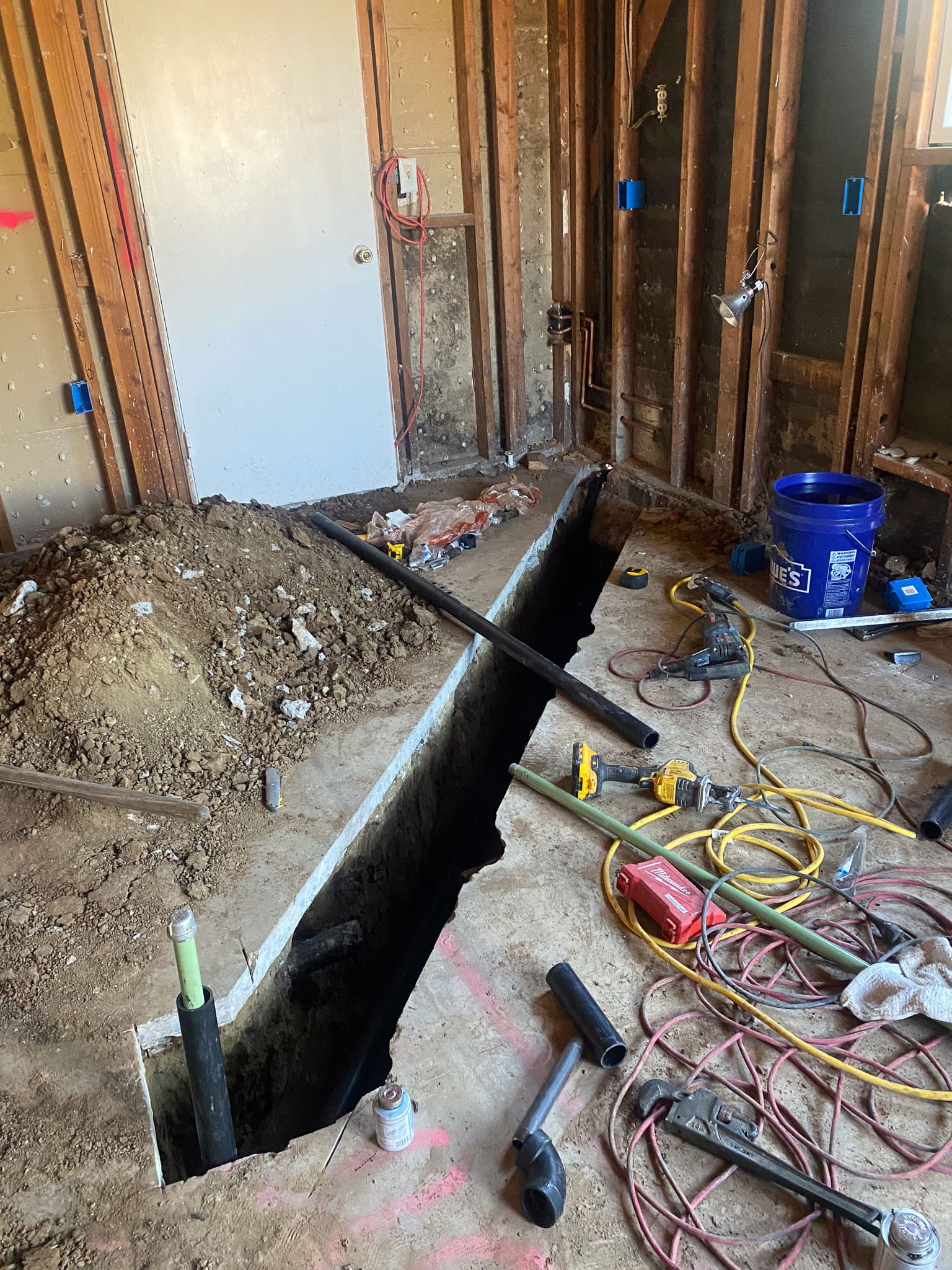 Trench in concrete slab for running a gas line to the new kitchen island cooktop location