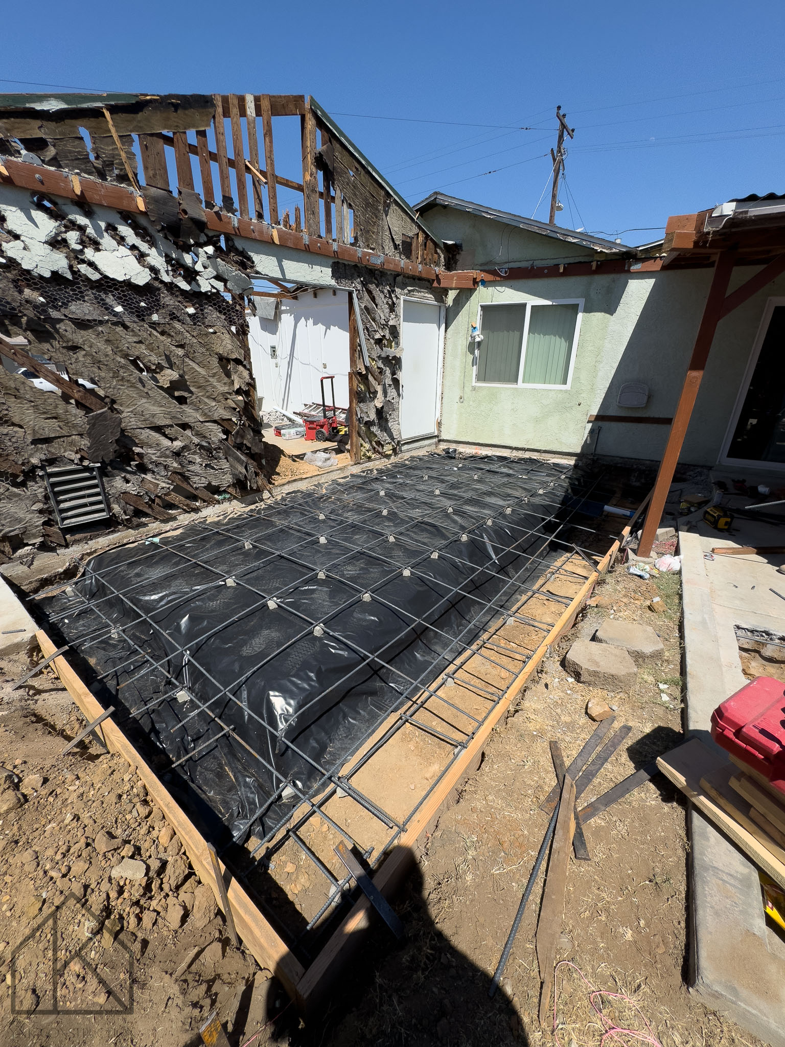 Preparation for pouring slab foundation extensions for a second floor addition